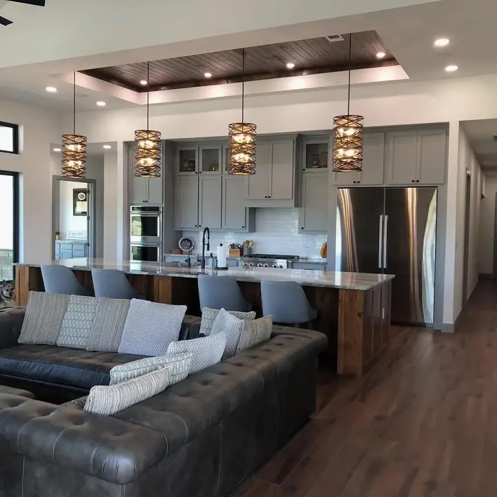 Open living room and kitchen with pendant lights over the island
