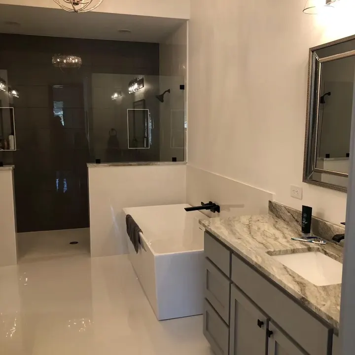 Bathroom with a freestanding tub, walk-in shower and marble vanity